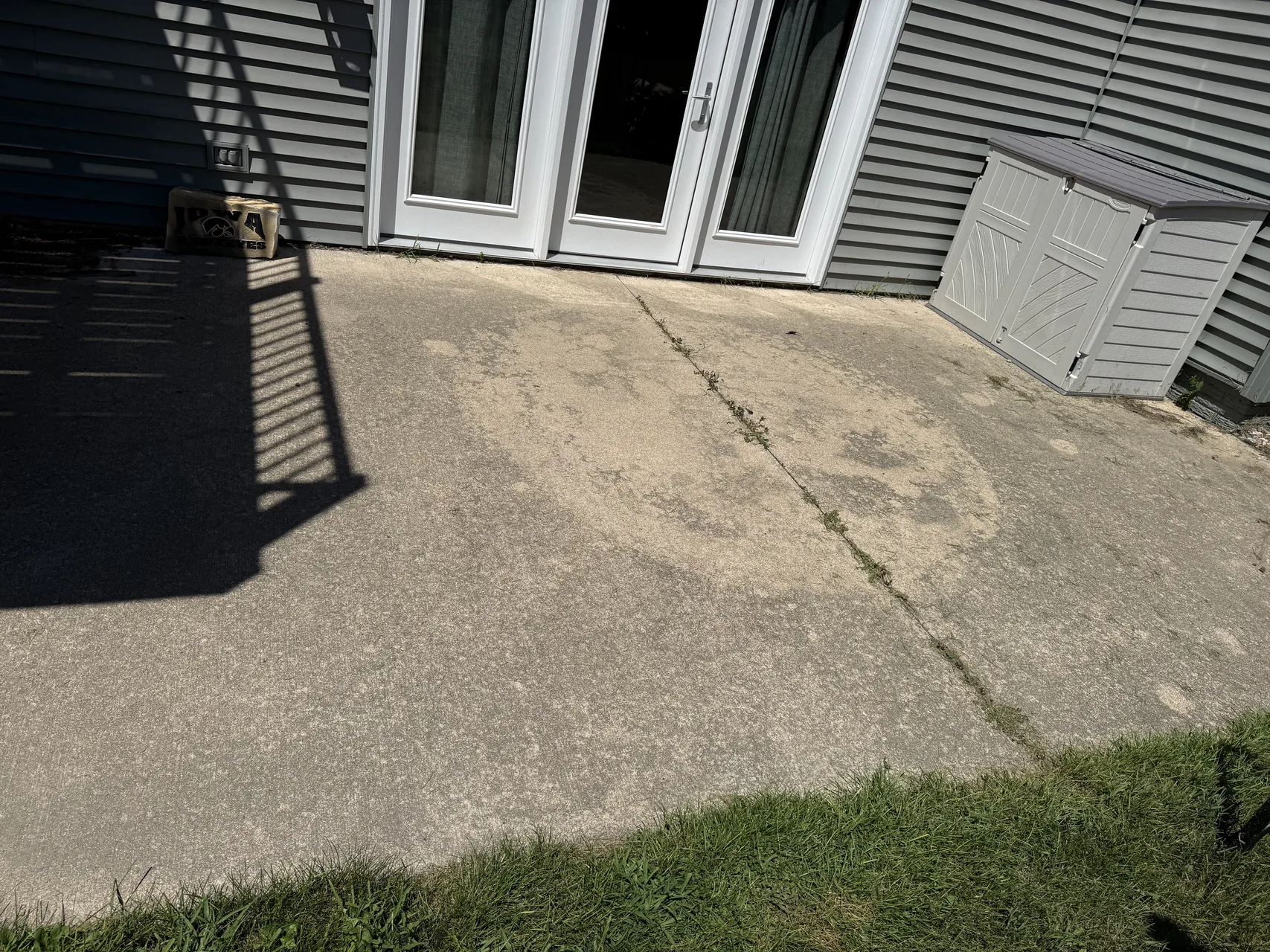 Client backyard concrete patio before cleaning